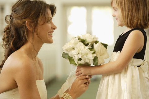 Bride handing bouquet to flower girl. Date : 2008