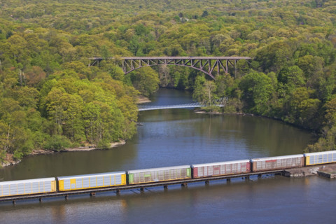 Cargo train on rail over river, New York, United States. Date : 2008