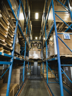 Warehouse worker driving forklift with palette. Date : 2008
