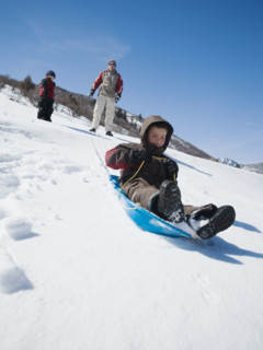 Boy riding on sled. Date : 2008
