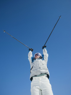 Woman holding ski poles over head. Date : 2008