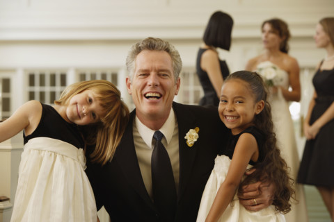 Father of bride hugging flower girls. Date : 2008