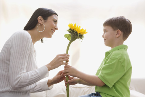 Son giving sunflower to mother. Date : 2008