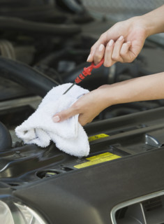 Mechanic checking oil.