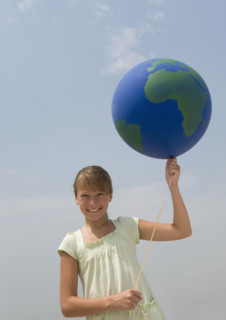 Girl holding globe balloon.