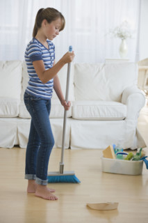 Girl cleaning livingroom.
