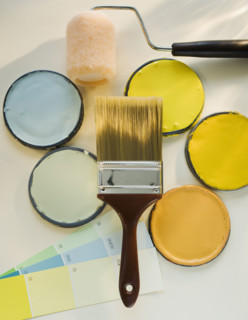 Paintbrushes and assorted paints.