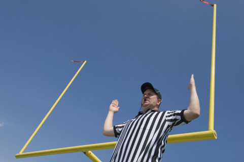 Football referee calling field goal.