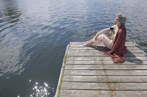 Senior woman sitting on dock.