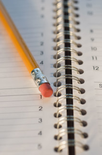 Close up of pencil and notebook. Date : 2008
