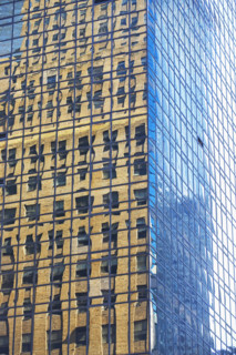 Old building reflected in modern building windows. Date : 2008