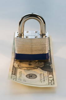 Close up lock and twenty dollar bill. Date : 2008