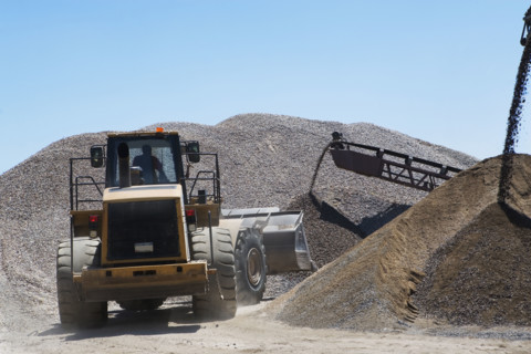 Bucket loader moving pile of gravel. Date : 2008