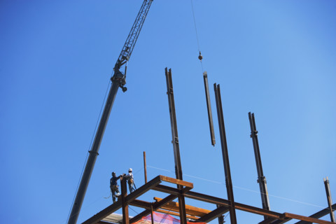 Low angle view of construction workers on beam. Date : 2008