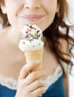 Teenage girl eating ice cream cone. Date : 2008
