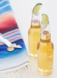 Refreshing beer bottles garnished with lime slices. Date : 2008