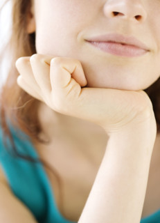 Close up of teenage girl resting head in hand. Date : 2008