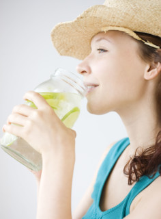 Teenage girl drinking refreshing lime water. Date : 2008