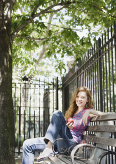 Woman relaxing on park bench. Date : 2008