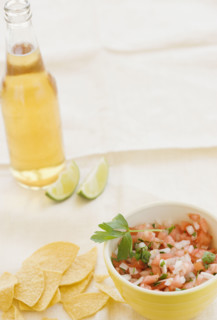 Close up of salsa, tortilla chips and beer. Date : 2008