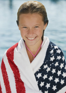 Girl wrapped in American flag towel.