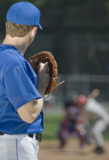 Baseball pitcher preparing to pitch ball.