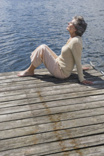 Senior woman sitting on dock.