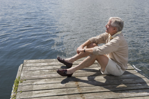 Senior man sitting on dock.