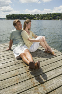Couple sitting on dock.
