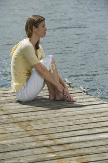 Woman sitting on dock.