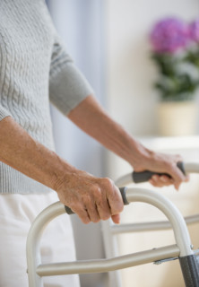 Senior woman using walker.
