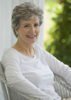Senior woman sitting on porch.