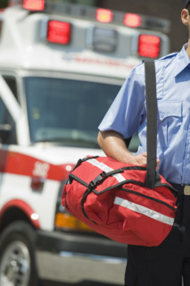 EMT carrying medical kit.