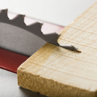 Close up of saw cutting wood.