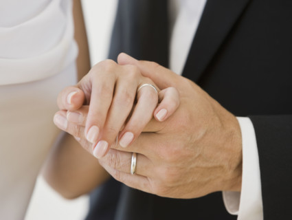 Married couple holding hands.