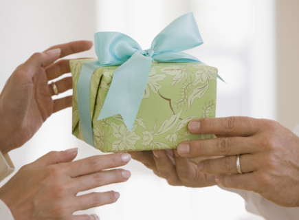 Man giving wife gift.