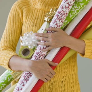 Woman holding wrapping paper.