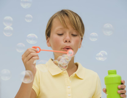 Girl blowing bubbles.