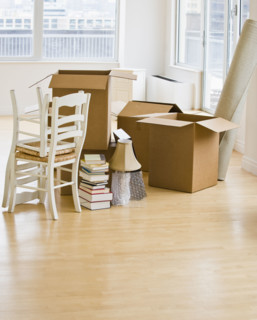 Moving boxes and chairs in livingroom.