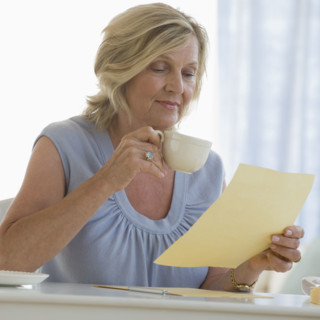Woman reading letter at home.