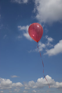 Balloon floating into sky.