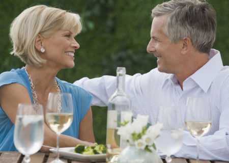 Couple enjoying wine outdoors.