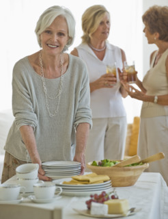 Senior women socializing at luncheon.