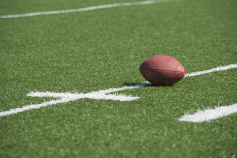 Football on yard line marker.