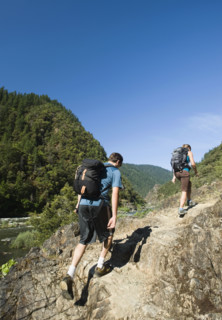 Hikers walking on riverside trail. Date : 2008