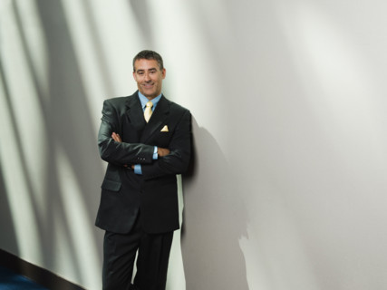 Businessman leaning against wall. Date : 2008