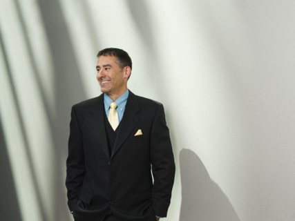 Businessman standing with hands in pockets. Date : 2008