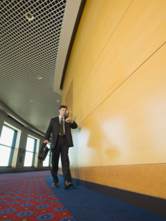 Businessman checking watch in corridor. Date : 2008