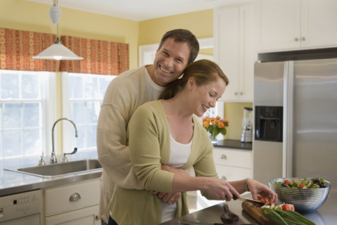 Couple making dinner in kitchen. Date : 2008