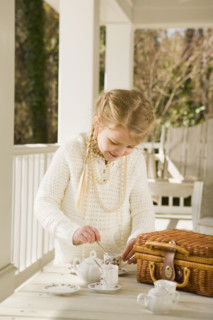 Girl having tea party on porch. Date : 2008
